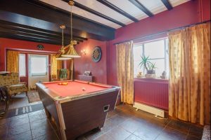 Ralph reviews a period property in holt games room 