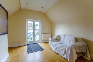 bedroom with french doors to a large patio in a house for sale in Farndon