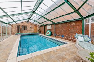 indoor heated swimming pool at a house for sale in Malpas