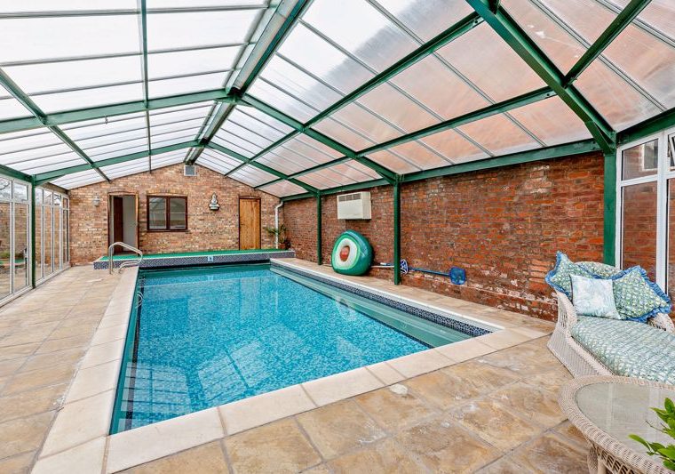indoor heated swimming pool at a house for sale in Malpas