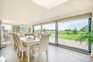 dining room with bifolding doors in a barn conversion for sale in Church Minshull