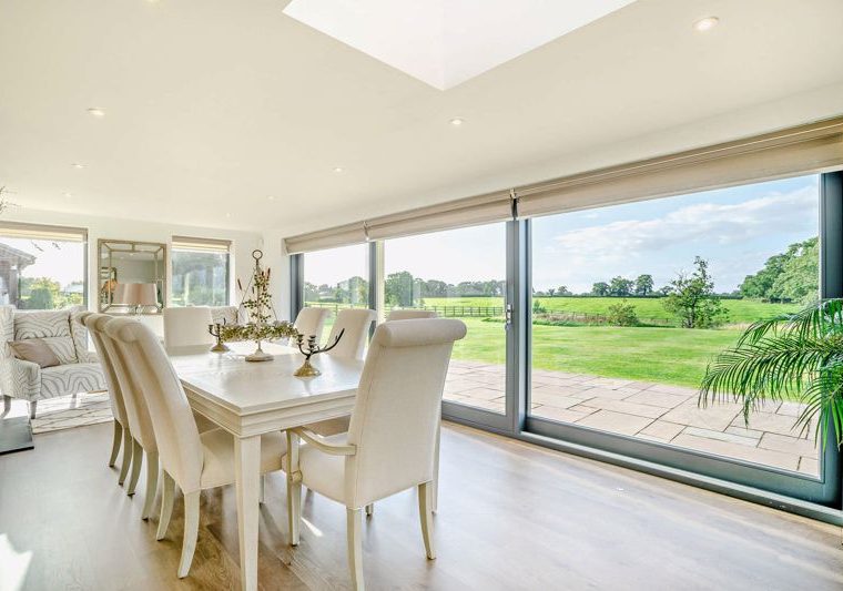 dining room with bifolding doors in a barn conversion for sale in Church Minshull