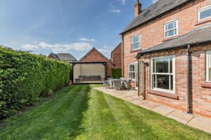 private garden with paved terrace and timber gazebo at a house for sale in Holt