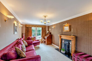 the sitting room with Edwardian fireplace in a house for sale in Holt